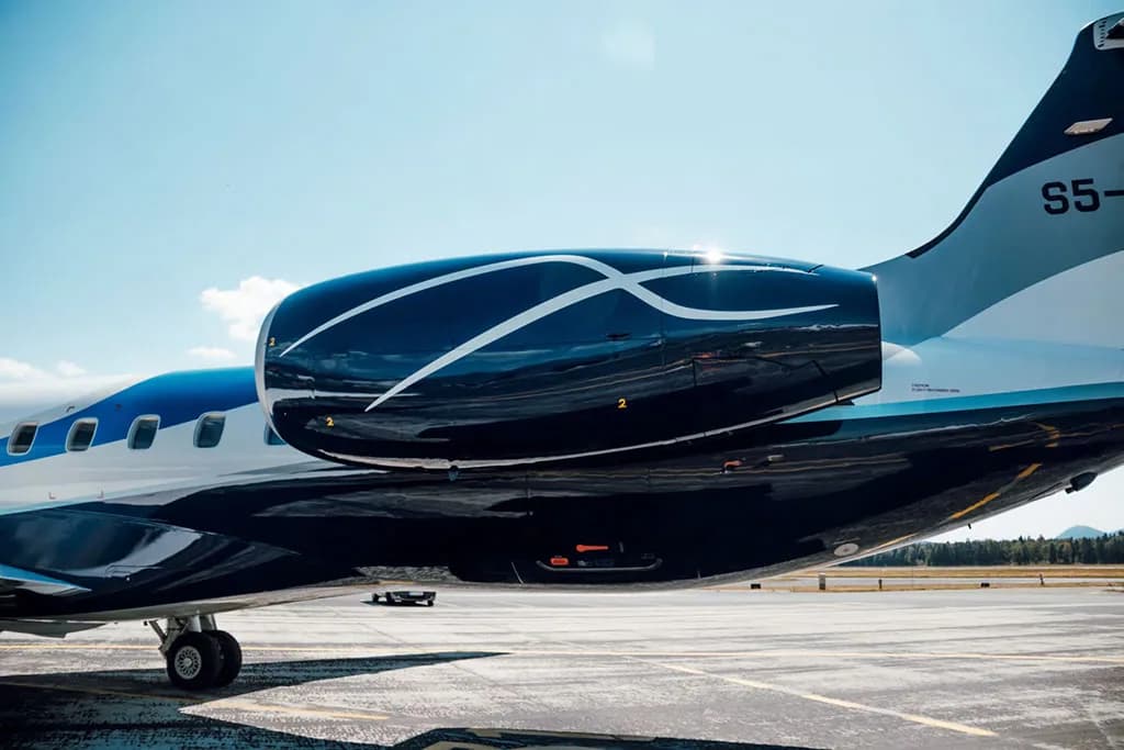 A close-up of the dark blue engine and tail section of an Embraer ERJ 145, showing the "S5-" registration.