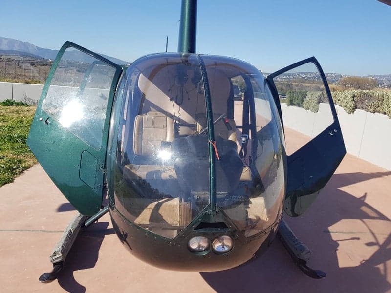 Front view of a Robinson R44 Clipper helicopter with open doors.