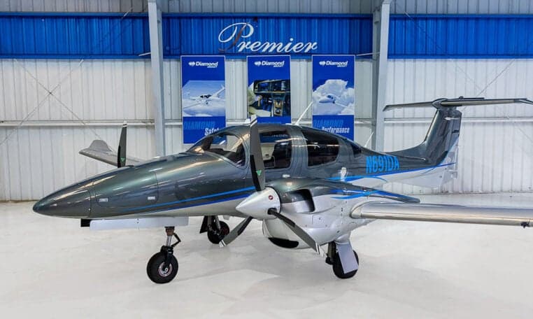 Diamond DA62 twin-engine aircraft in a hangar setting.