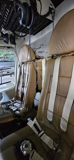 A view of the tan leather seats in the helicopter cabin.