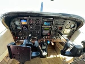 The instrument panel of the Cessna 182 Skylane, showing various gauges and controls.