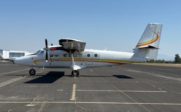 Front view of a Twin Otter aircraft on the tarmac.