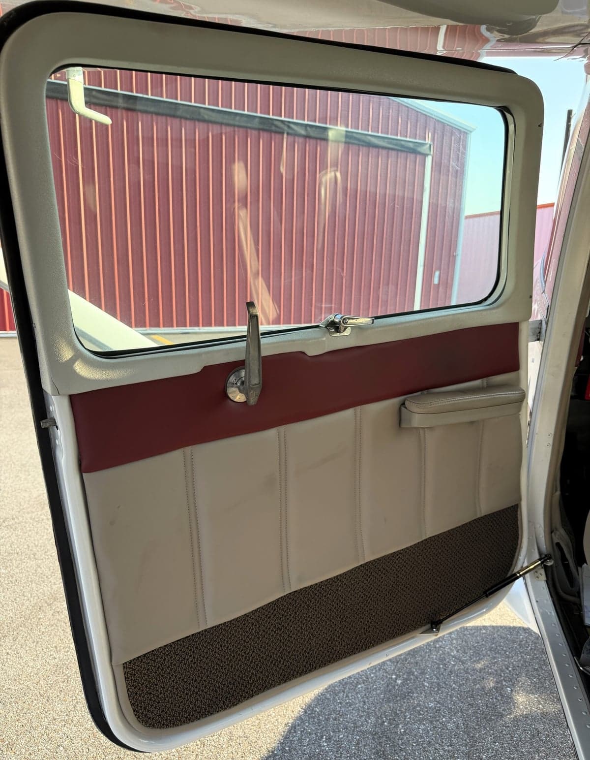 An open door reveals the interior paneling of the aircraft.