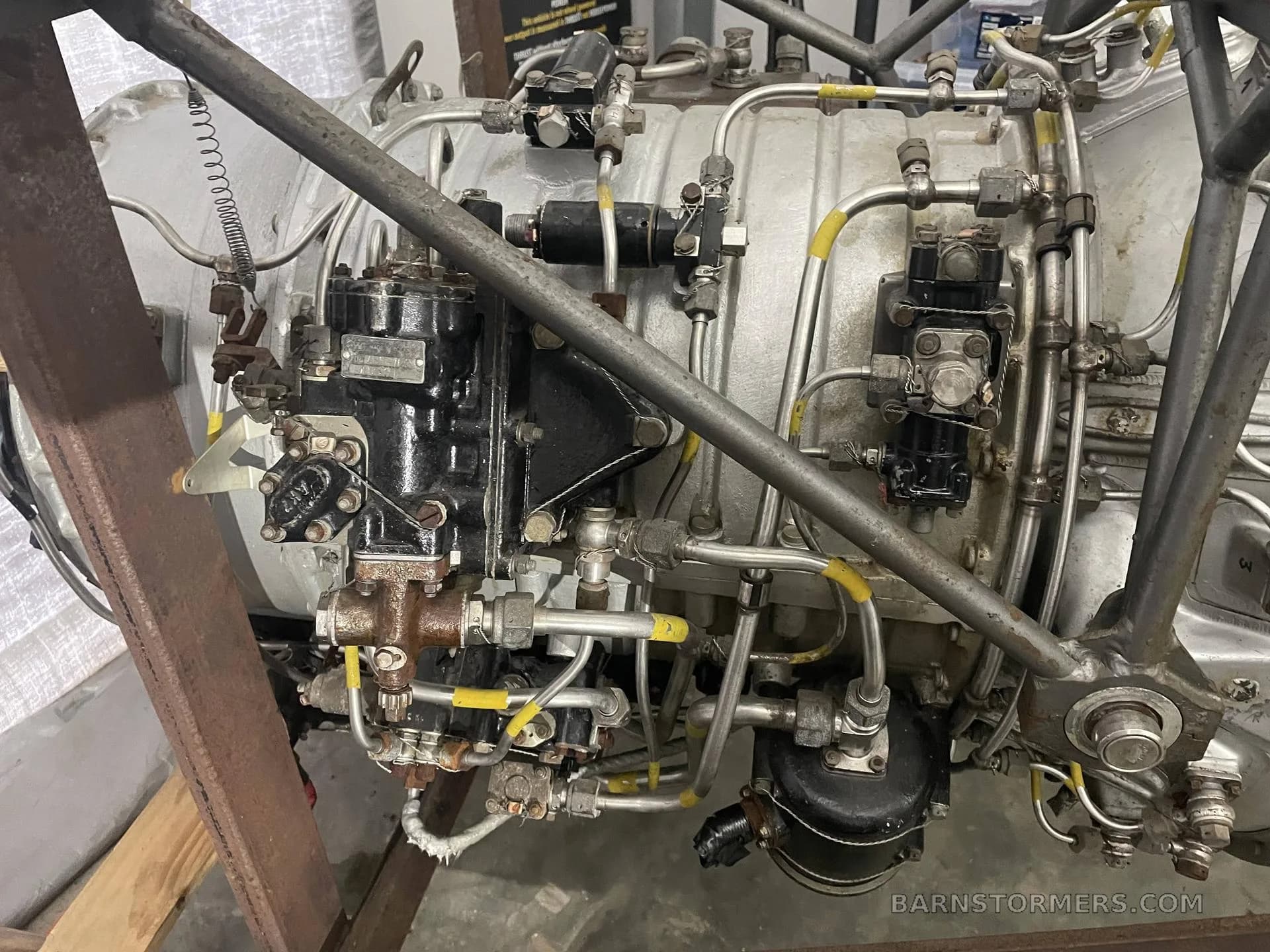 A detailed close-up view of the complex piping and components on the side of a jet engine.