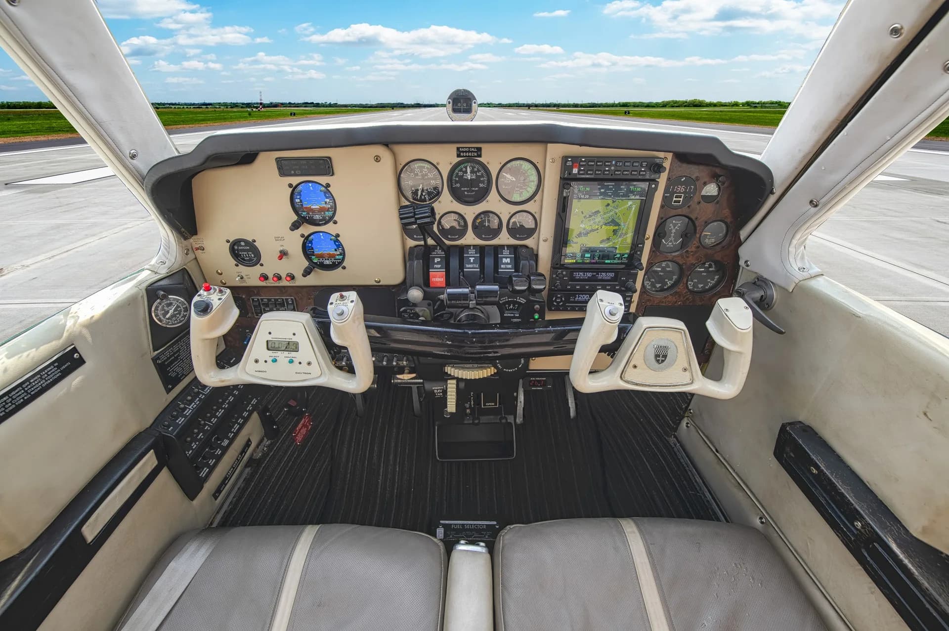 Detailed view of the Beechcraft Bonanza instrument panel and control yokes.