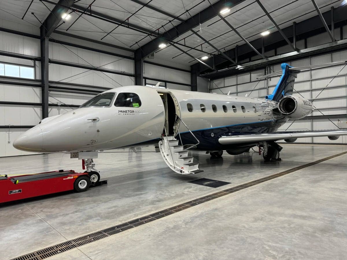 N602EE Praetor 600 aircraft in a hangar with the entry stairs down.