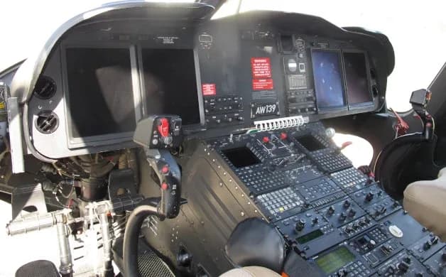 The cockpit of an AgustaWestland AW139 helicopter, featuring multiple display screens and control panels.