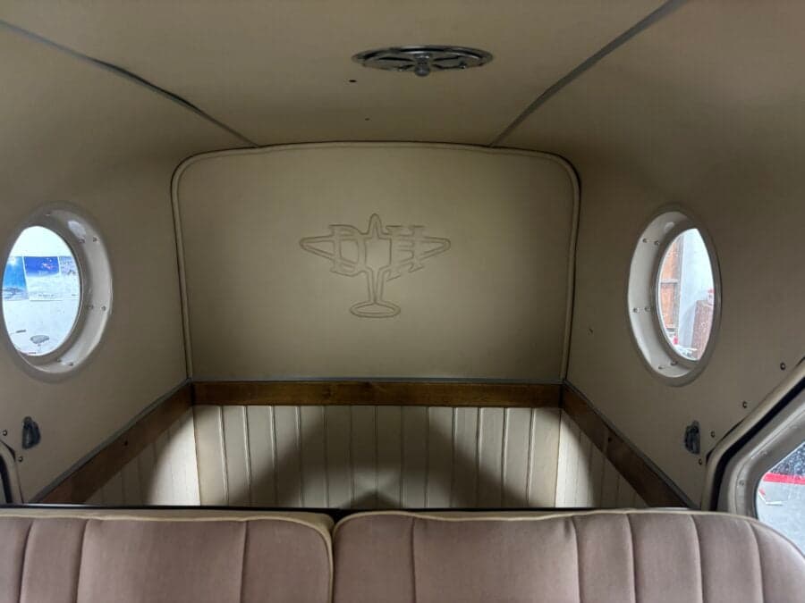 View of the rear of the cabin, showing the seats and a logo on the back wall.