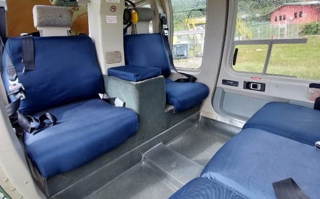 Helicopter interior with blue seats.