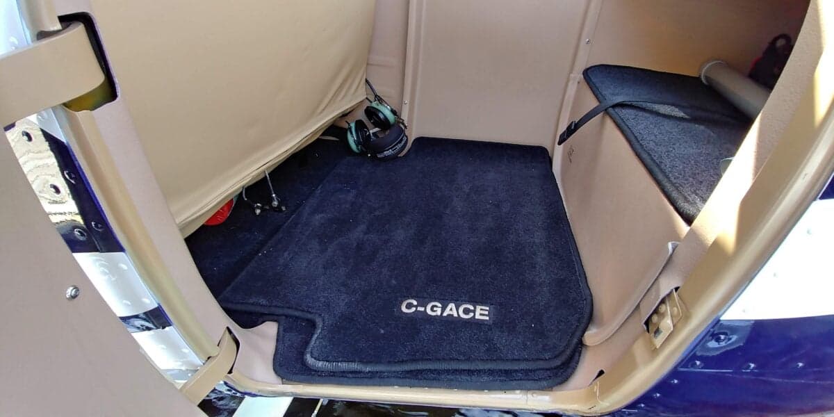 View of the floor and storage area of the aircraft interior.