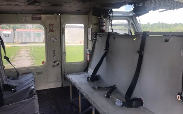 Interior of a Bell 212 helicopter with bench seats.
