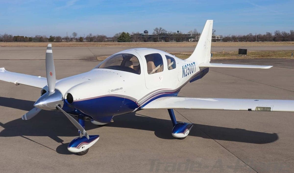 Three-quarter front view of a white and blue Columbia 400 aircraft with registration N2500T on an airfield.