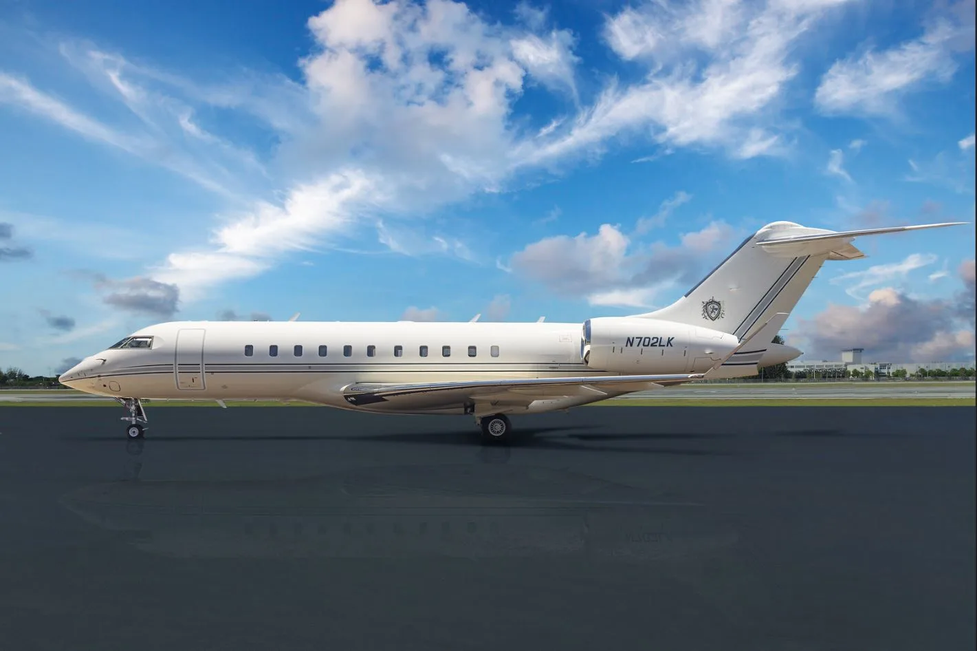 Side view of a white private jet with tail number N702LX.