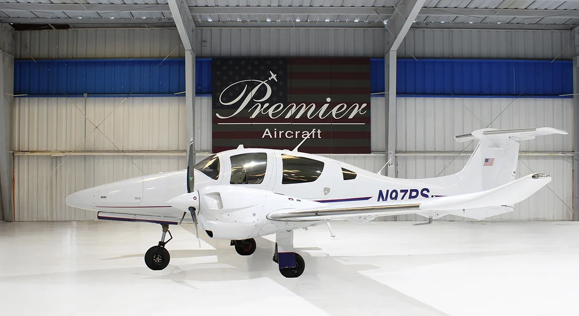 Diamond DA62 aircraft with registration N97PS parked in a hangar.