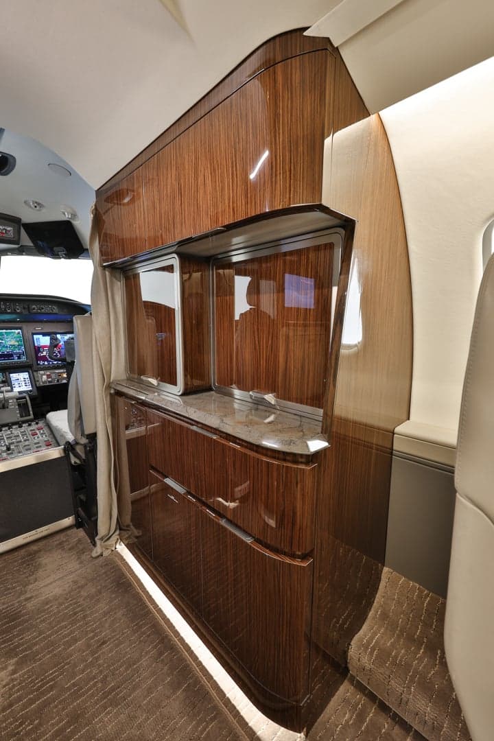 View of the Learjet 45XR interior with wood cabinetry.