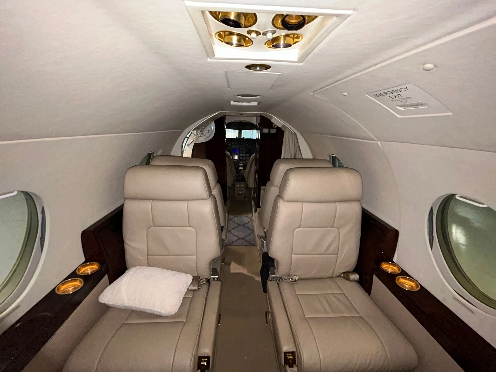 View of the aircraft interior seats and cockpit.