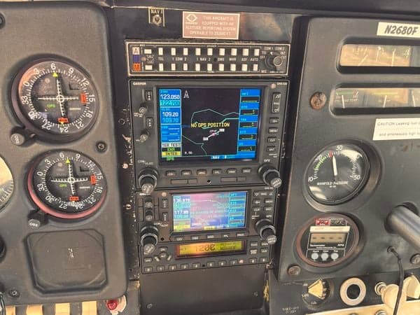 The cockpit of the aircraft N2680F shows the GPS navigation system and radio stack.