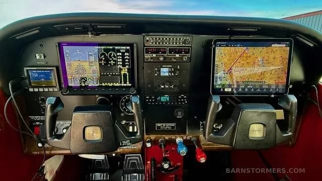 The cockpit of a small aircraft, featuring modern glass panel displays and a tablet mounted on the right yoke.