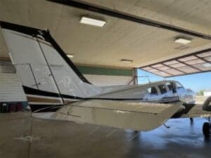 Tail section of N728HS aircraft inside a hangar.