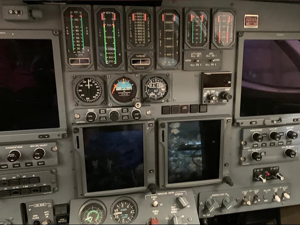 A detailed view of the aircraft's cockpit instrument panel with various gauges and screens.