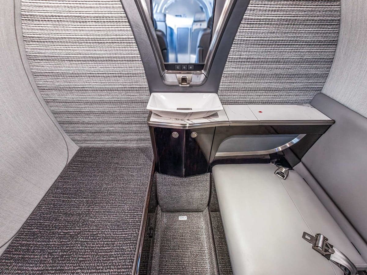 View of the Citation CJ4 cabin featuring a side-facing seat and a small sink.