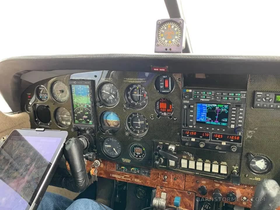 The cockpit instrument panel features a mix of analog gauges and modern digital displays.