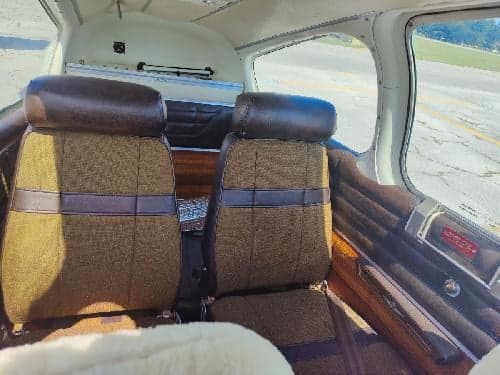 View of the aircraft's interior seats and side panel.