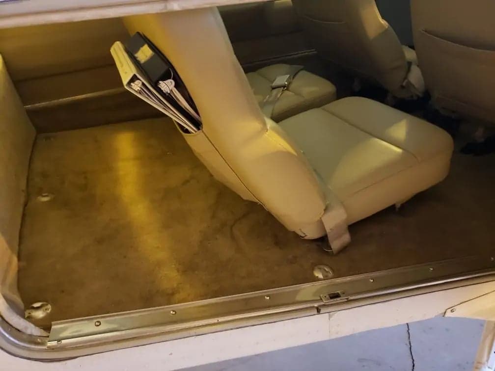 View of the aircraft's cabin seats and carpet.