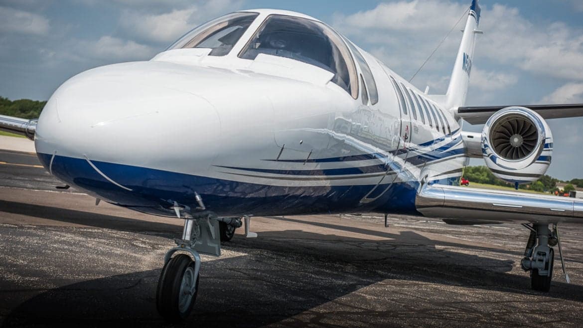 Close up of the nose and engine of a Citation Encore aircraft.
