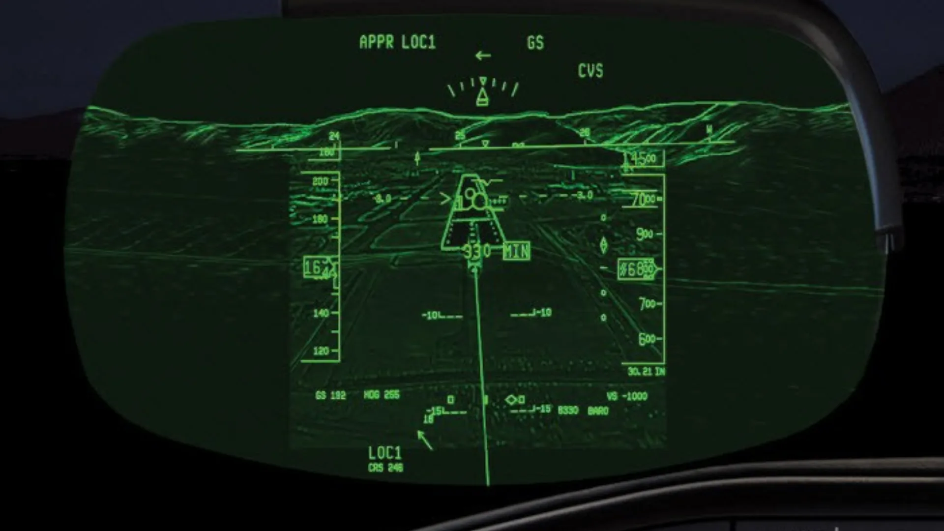 A green head-up display (HUD) showing flight path, altitude, speed, and terrain for an approach.