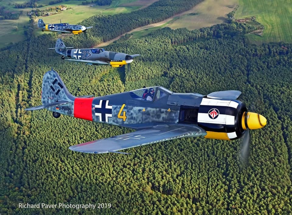 A Focke-Wulf Fw 190 aircraft in flight over a lake.