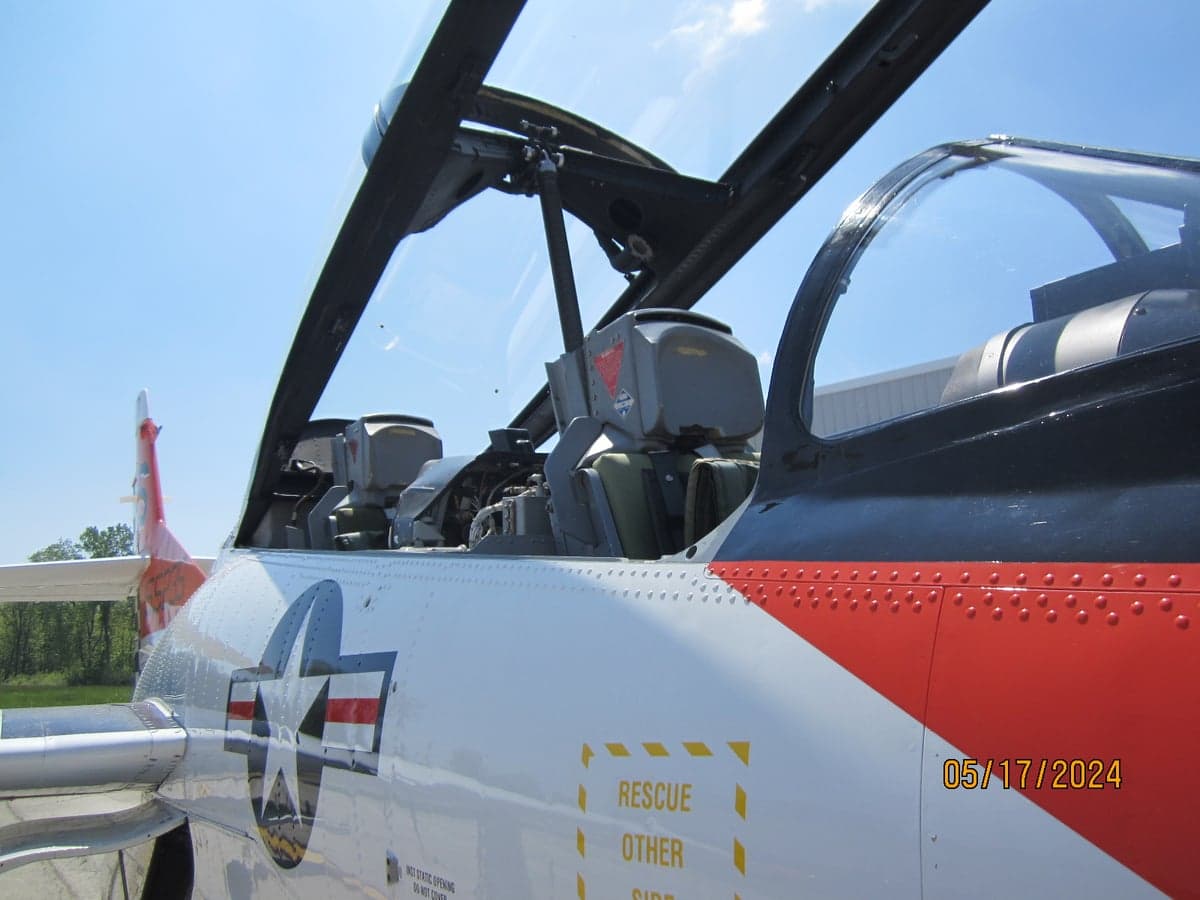 Close-up view of the T-2B Buckeye aircraft's cockpit and side markings.