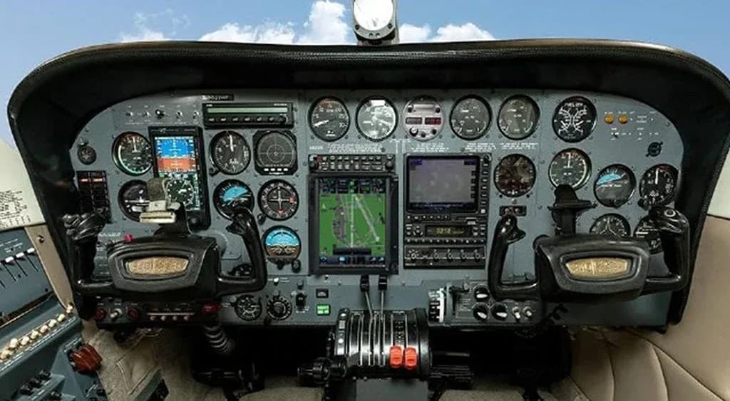 The aircraft's cockpit with a detailed instrument panel, including multiple gauges and screens.