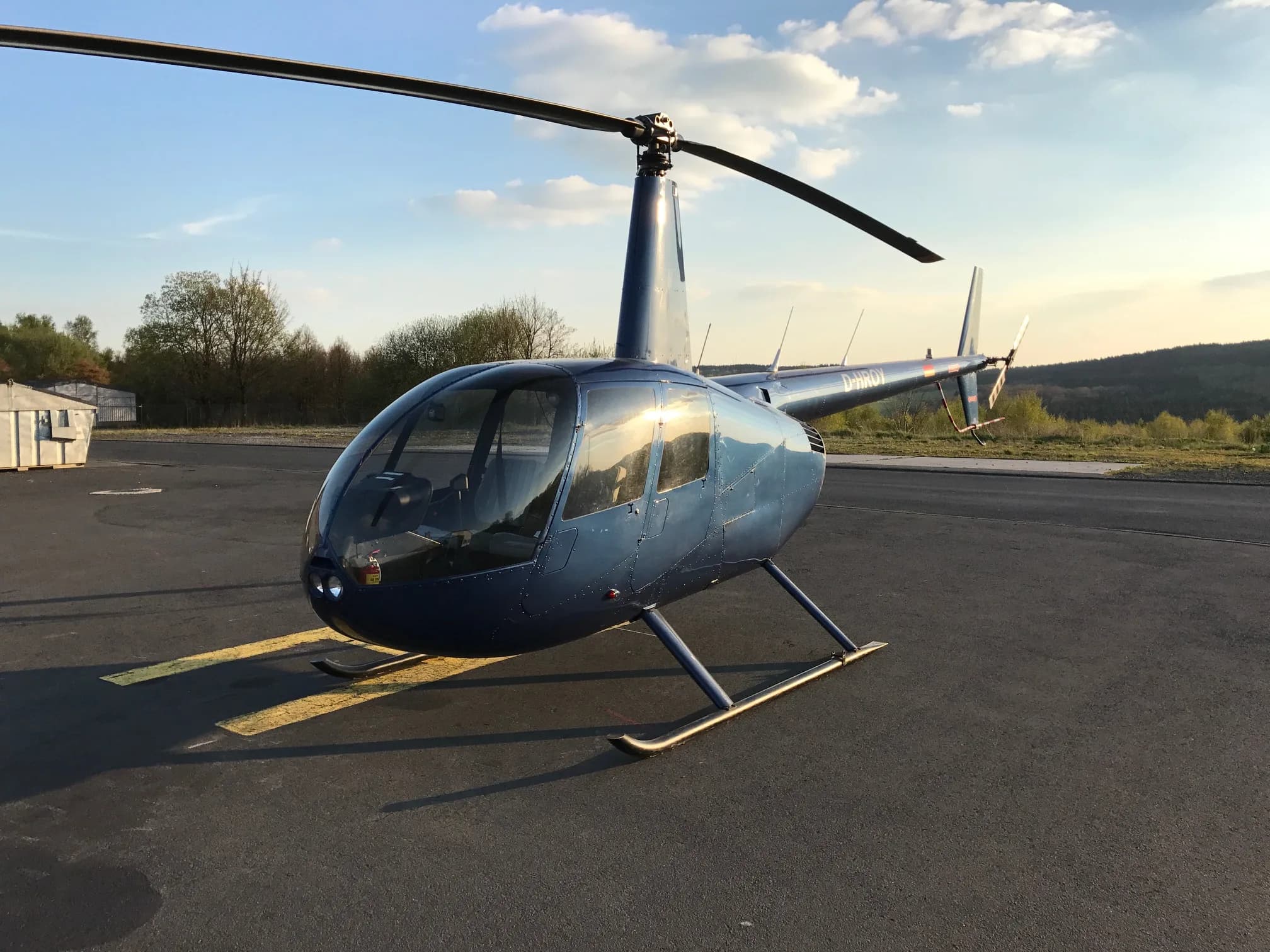 Robinson R44 Raven I OE-XXQ helicopter on the ground.