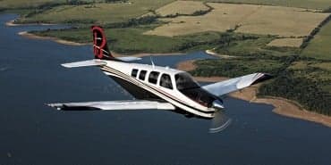 Side view of a light aircraft with a black background.