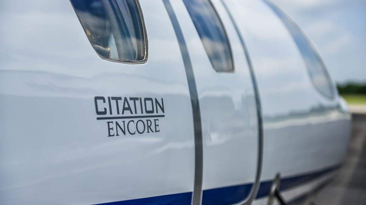 Close up of the Citation Encore logo on the side of the aircraft.