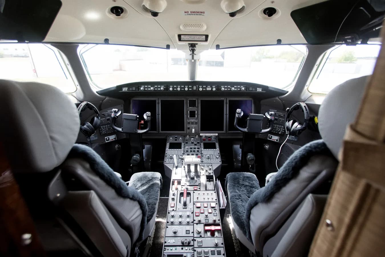 View of the aircraft cockpit with instrument panel and seats.