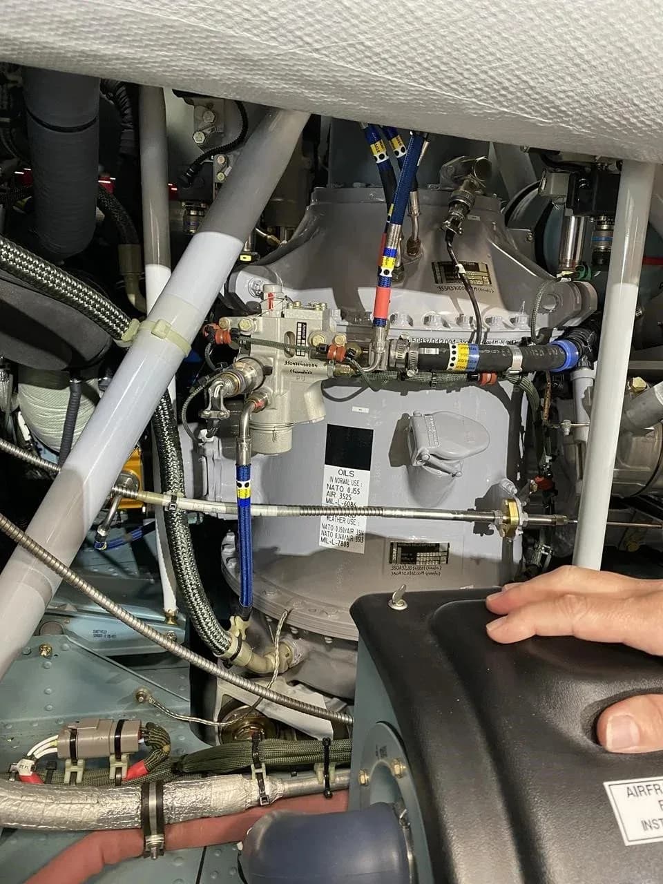 A detailed view of the helicopter's engine compartment, showing various mechanical components and wiring.