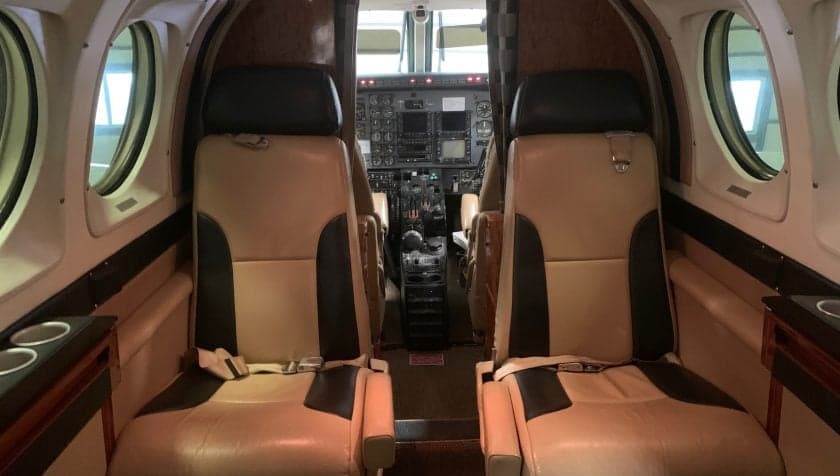 View of the aircraft's interior, showing the cockpit and forward passenger seats.