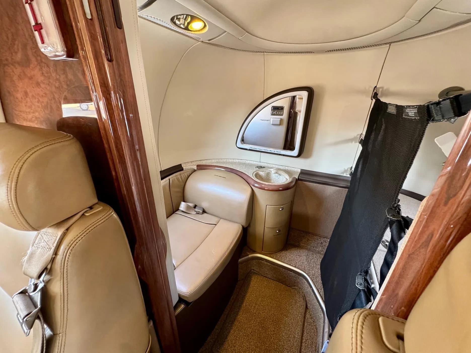 View of the aircraft interior with a seat and small sink.