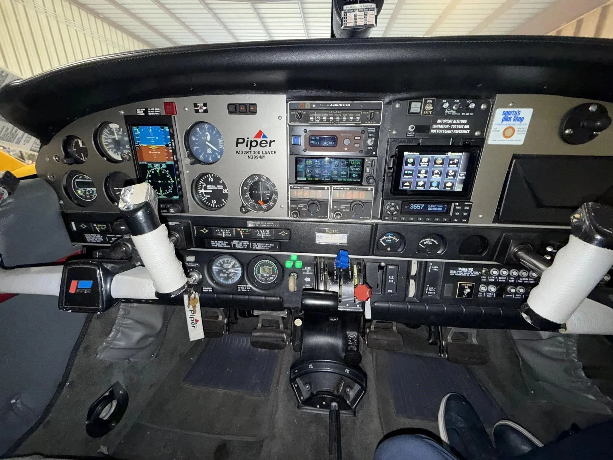 The cockpit instrument panel of the Piper Lance II aircraft, featuring various gauges and avionics.
