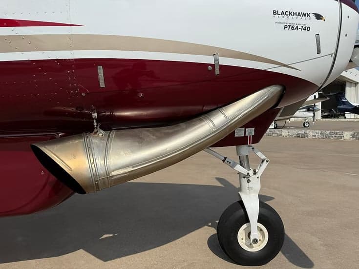 Close up of the exhaust pipe and landing gear of the Cessna Caravan.