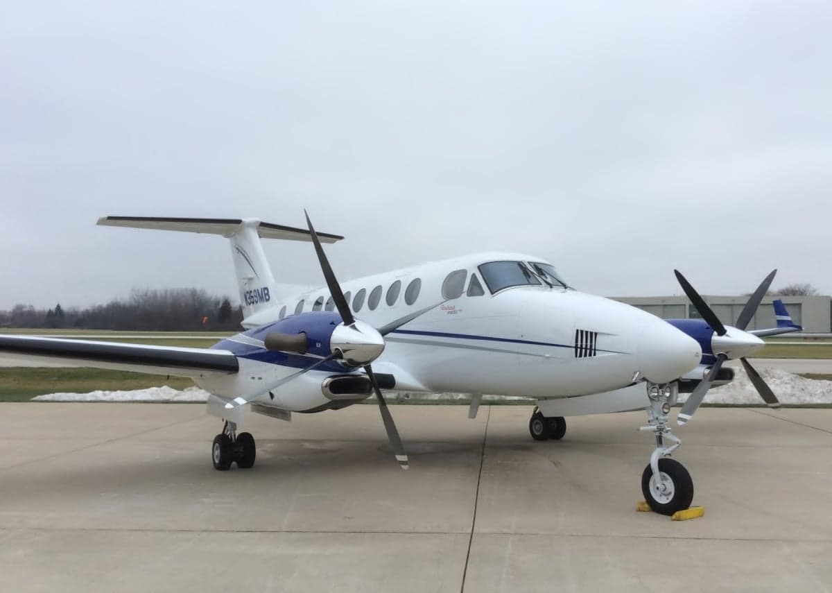 A King Air turboprop aircraft is parked on the tarmac.