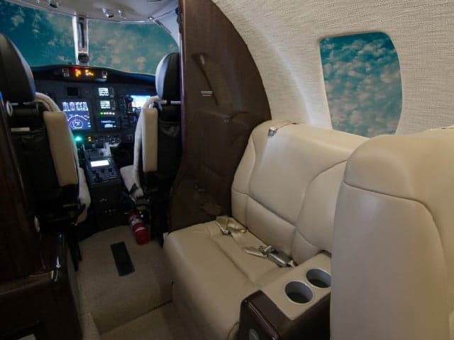 View of the Cessna Citation CJ3+ cabin showing the cockpit and passenger seating.