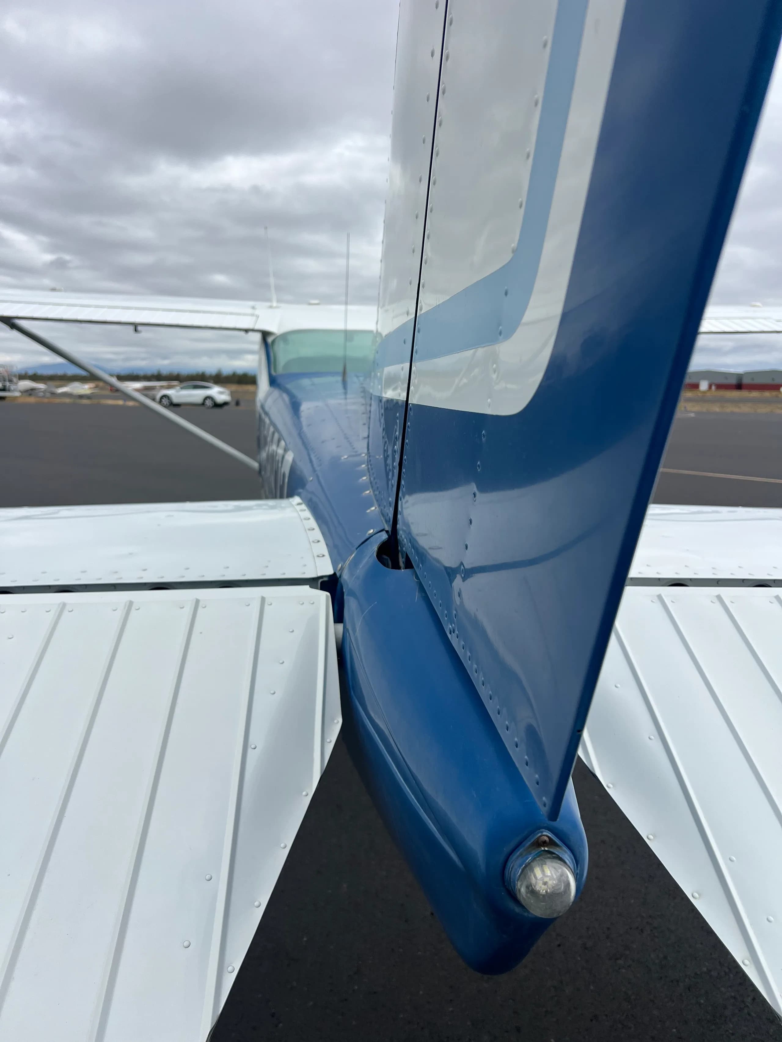 A close-up view of the blue and white tail section and horizontal stabilizer of the Cessna 172 aircraft.