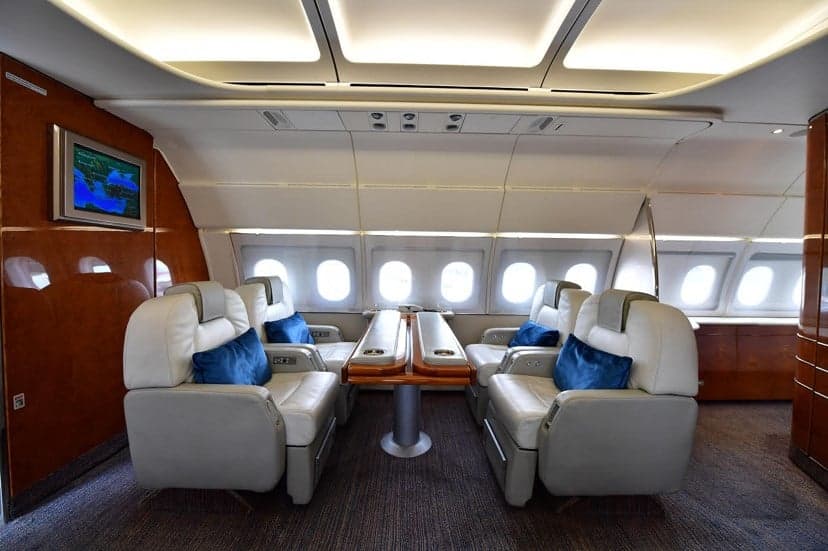 Interior of the aircraft with white seats and a table.