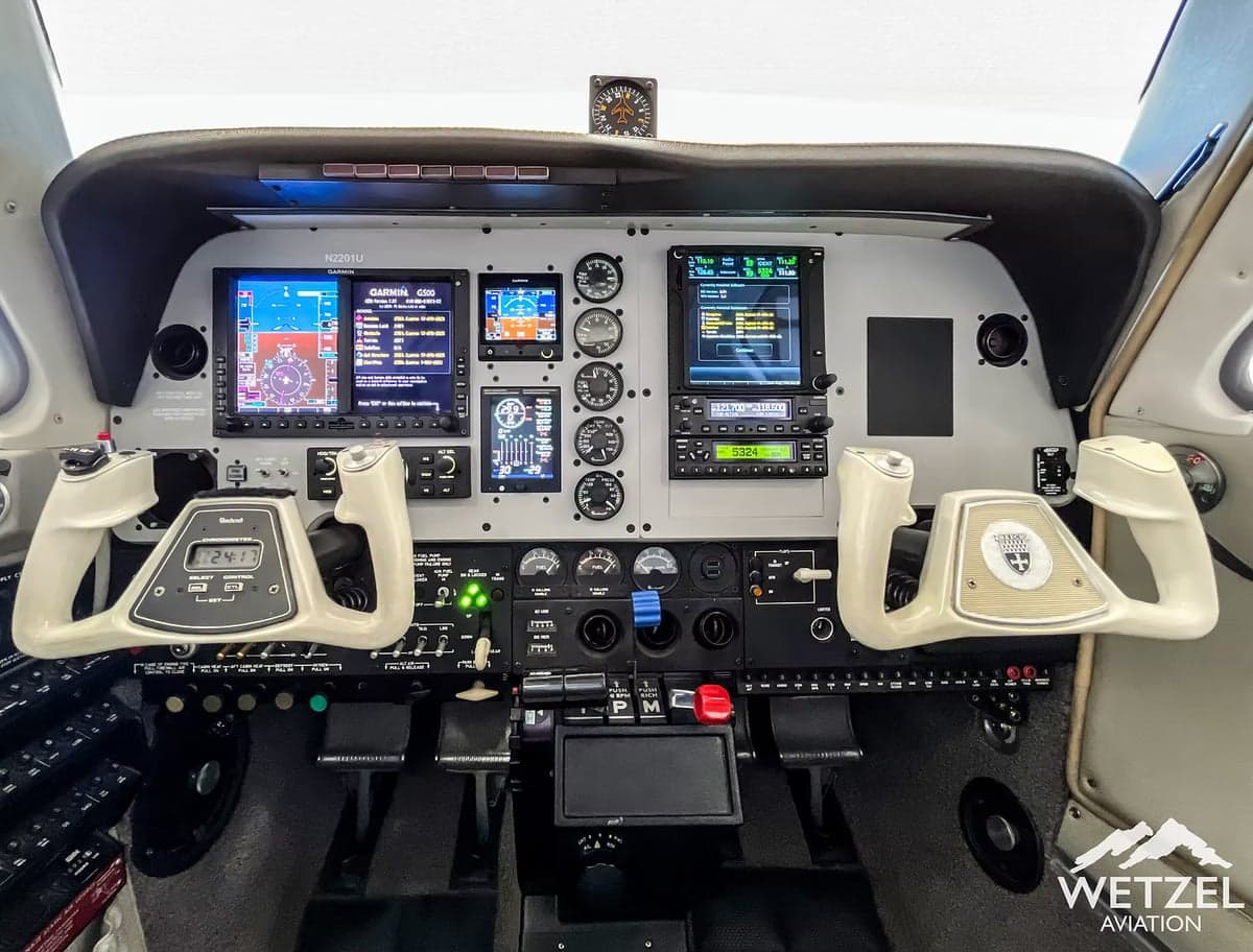 The cockpit of the aircraft features a modern glass panel display and traditional flight controls.