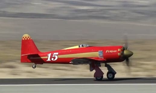 Side view of a red and gold Furias aircraft with the number 15 on the side.