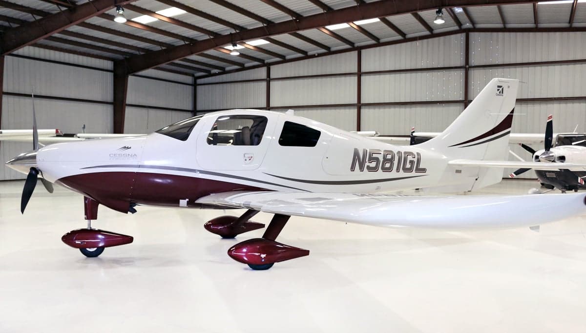 Side profile of a Cessna Corvalis TT aircraft with a white and maroon paint scheme.