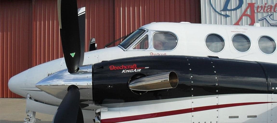 Close-up of the Beechcraft King Air 350's engine and nose, showing the Beechcraft logo.